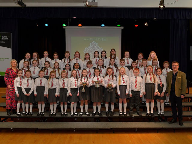 Holy Family Primary School choir, winners the Unison Cup, Adjudicator’s Award and the Susan Browne Cup at the Derry Feis Choir Competitions held in St Mary’s College on Tuesday. Included in the photograph is Competition Adjudicator Richard Yarr. Photo: George Sweeney. DER2314GS – 04