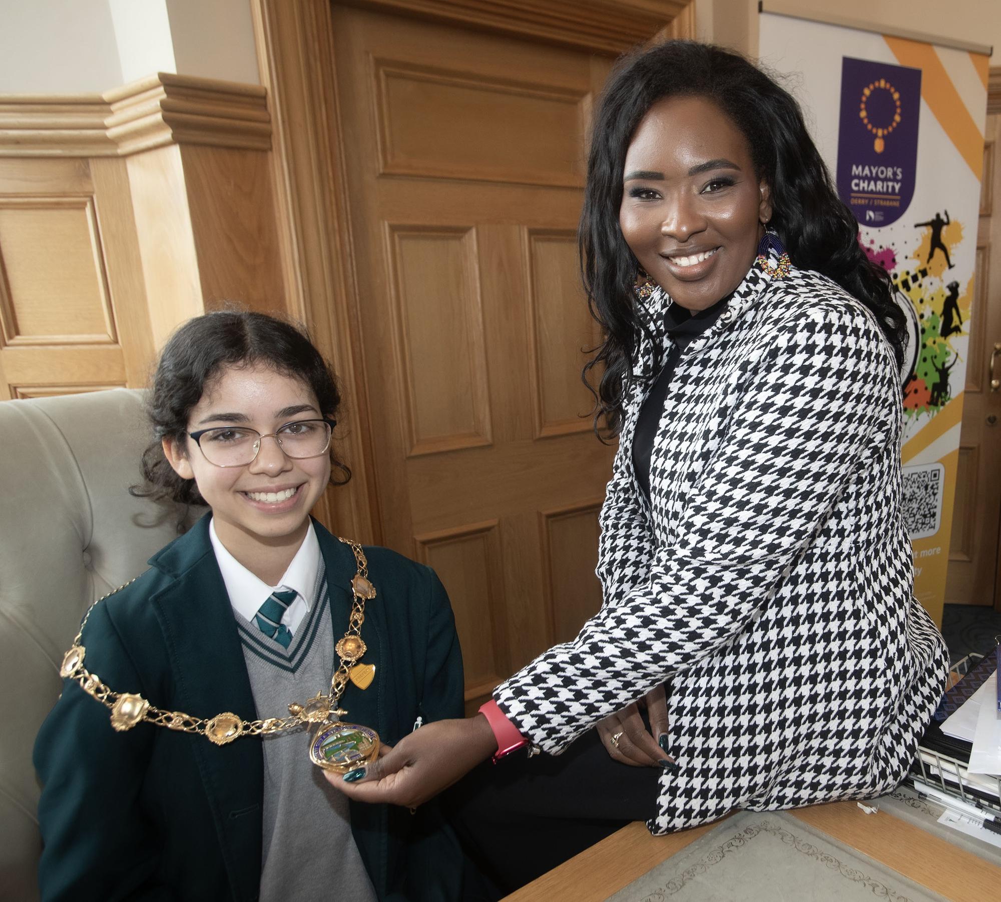 The Mayor, Lilian Seenoi-Barr showing her chain of office to Sarah Gad during Thornhill College's Junior Priefects visit to the Thornhill on Tuesday.