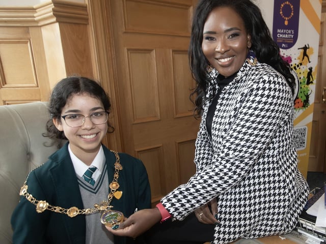 The Mayor, Lilian Seenoi-Barr showing her chain of office to Sarah Gad during Thornhill College's Junior Priefects visit to the Thornhill on Tuesday.