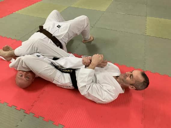 Aileach Karate Club instructor, Seamus Gillespie, performs a self defence demonstration with the help of clubmate Gareth Walker.