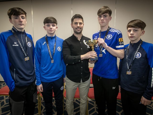Special guest Stephen McKendry presenting representatives of the Trojans u-14 team with the Rambo Gillespie Cup at the Annual D&D Youth FA awards on Friday night. Included are coaches Rich Stewart, Alwyn Hunt and Ali White. (Photos: Jim McCafferty Photography)