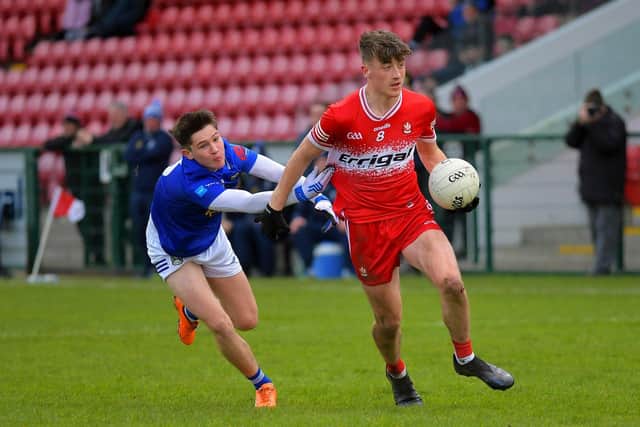 Derry's James Sargent keeps Conor Doyle of Cavan at arm's length in Owenbeg. Photo: George Sweeney