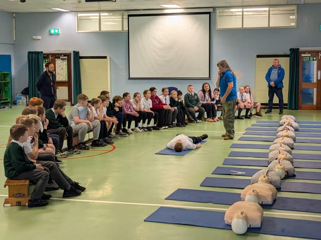 Heart of Foyle volunteers explaining basic life support at Greenhaw Primary School.
