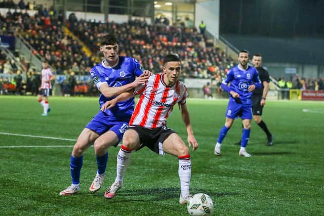 Jordan McEneff holds off Robbie McCourt during Derry City's big win over Waterford.