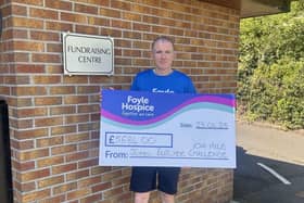 John Butcher pictured presenting a cheque for £5,584 , proceeds from running 104 miles throughout Limavady in aid of Foyle Hospice.