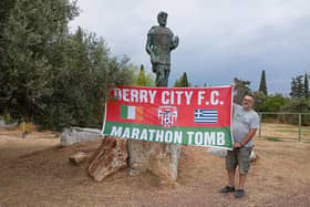 George Fertakis pictured with his Derry City FC banner at the statue of Miltiadis in Marathon.
