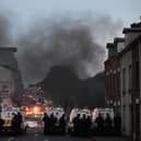 BALLYMENA, NORTHERN IRELAND - JUNE 10: PSNI riot squad officers respond to protesters throwing projectiles and setting vehicles on fire on June 10, 2025 in Ballymena, Northern Ireland. (Photo by Charles McQuillan/Getty Images)