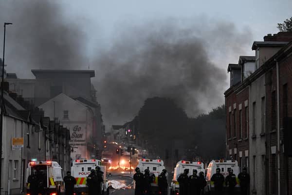 BALLYMENA, NORTHERN IRELAND - JUNE 10: PSNI riot squad officers respond to protesters throwing projectiles and setting vehicles on fire on June 10, 2025 in Ballymena, Northern Ireland. (Photo by Charles McQuillan/Getty Images)
