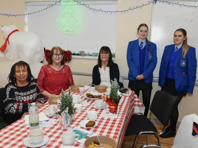 Local residents pictured with volunteer helpers from St Mary’s College pictured at the Ballymagroarty Hazelbank Community Partnership ‘Season of Thanks’ Christmas dinner held in the community centre. Photo: George Sweeney