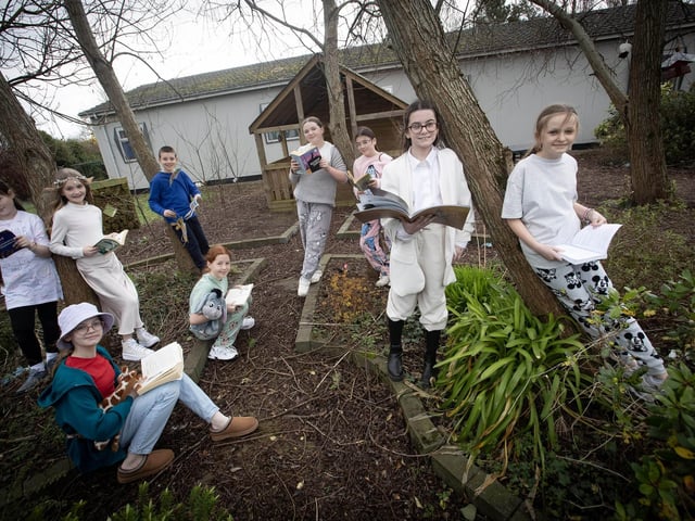 Some of Mrs. Rutherford's P7 pupils take time out for a quiet read in the Hollybush PS garden on Thursday to celebrate World Book Day. (Photos: Jim McCafferty Photography)