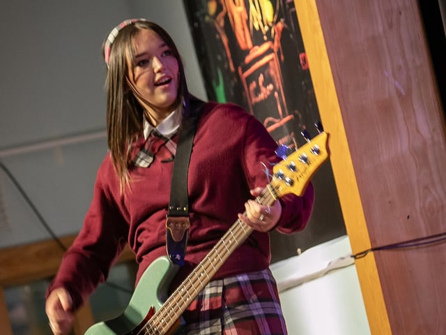 One of the performing guitarists pictured on the wings during Thursday night's production.