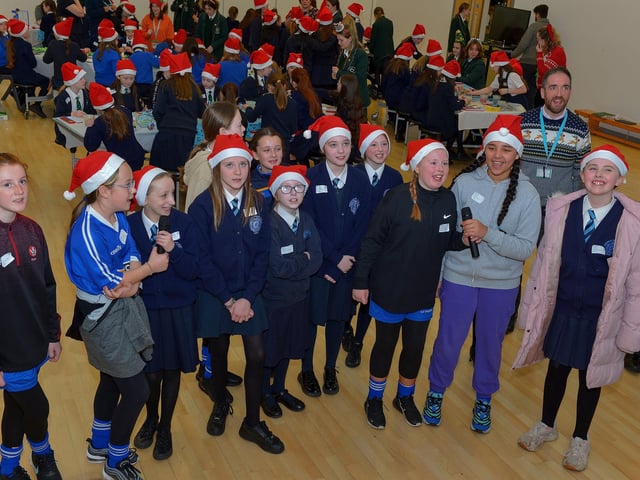 Pupils from St Brigid’s Primary School enjoy the carol singing at the St Cecilia’s College Christmas Workshop on Friday morning. Photo: George Sweeney. DER2248GS – 85