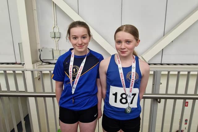 Maeve McGeehin and Ciara McDaid are all smiles with their podium finishes in the U14 girls Shot Put.