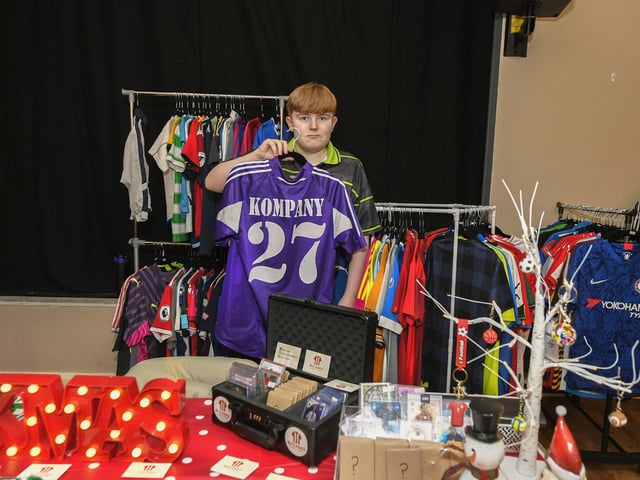 Rónán McDaid pictured with some of his football shirts and memorabilia at the Galliagh Christmas Craft Fair held in Pio House. Photo: George Sweeney