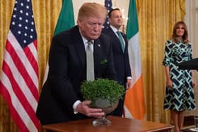 2019: US President Donald Trump holds a bowl of shamrocks presented to him in Washington, DC, March 14, 2019. (Photo by SAUL LOEB /AFP via Getty Images)