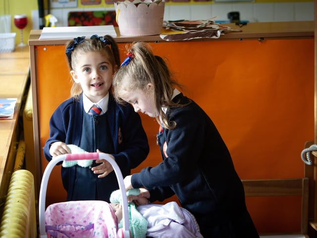 Priagh and Tyla putting getting the baby ready to go outside to the playground.