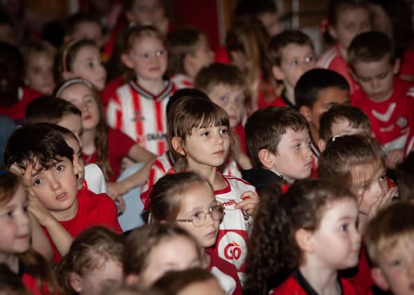 Not a spare inch in the hall! Full house for a special occasion as the Derry City players arrive at Hollybush PS on Tuesday.