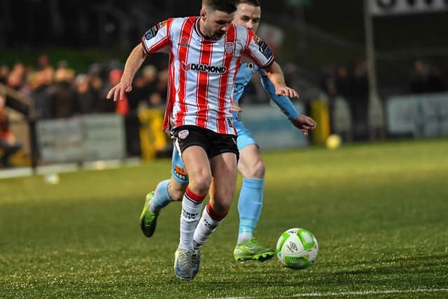 Dom Thomas of Derry City skips past Benny McLaughlin of Institute. Photograph: George Sweeney