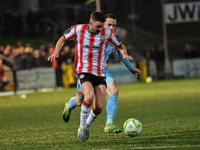 Dom Thomas of Derry City skips past Benny McLaughlin of Institute. Photograph: George Sweeney