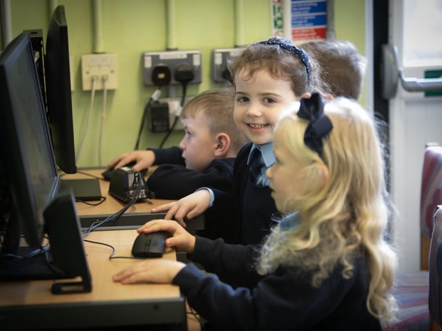A big smile from P1 pupil Sophia while the rest concentrate on their computer screens. (Photos: Jim McCafferty Photography)