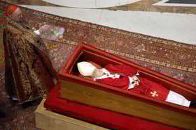Irish-born US Cardinal Kevin Joseph Farrell holds incense next to Pope Francis' coffin at the Basilica at St Peter’s Square on April 23, 2025 in Vatican City, Vatican. On the third day since the death of Pope Francis was announced by the Vatican, his body is transferred from the Chapel of Santa Marta to the Basilica St Peter. He will lie in state in a simple wooden coffin until his funeral, which will be held on Saturday, 26th April 2025.  (Pool photo by Mario Tama/Getty Images)