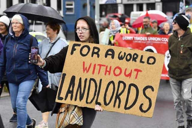 Participants carry placards during the Derry Housing Action Committee protest march over housing crisis on Saturday afternoon Photo: George Sweeney