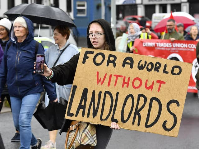 Participants carry placards during the Derry Housing Action Committee protest march over housing crisis on Saturday afternoon Photo: George Sweeney