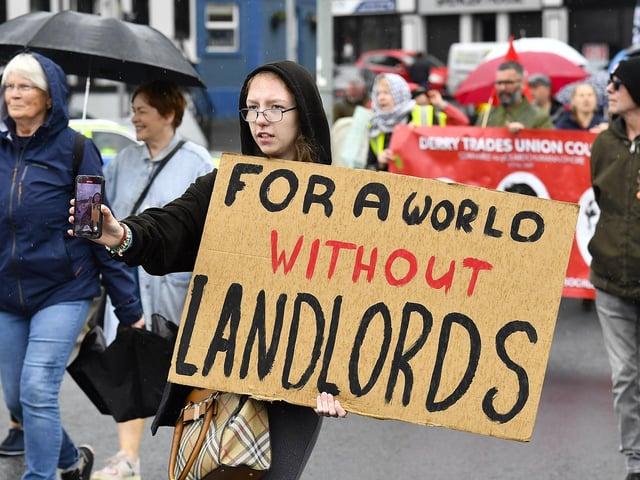 Participants carry placards during the Derry Housing Action Committee protest march over housing crisis on Saturday afternoon Photo: George Sweeney