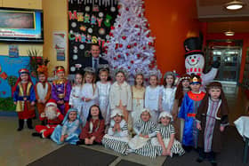 Pupils from Mrs Logue's P1 class at St Eithne]s Primary School, who performed their Nativity Play on Wednesday for family and relatives, pictured with Mr Terence McDowell school principal. Photo: George Sweeney. DER2249GS - 06
