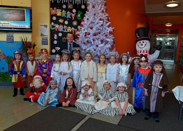 Pupils from Mrs Logue's P1 class at St Eithne]s Primary School, who performed their Nativity Play on Wednesday for family and relatives, pictured with Mr Terence McDowell school principal. Photo: George Sweeney. DER2249GS - 06