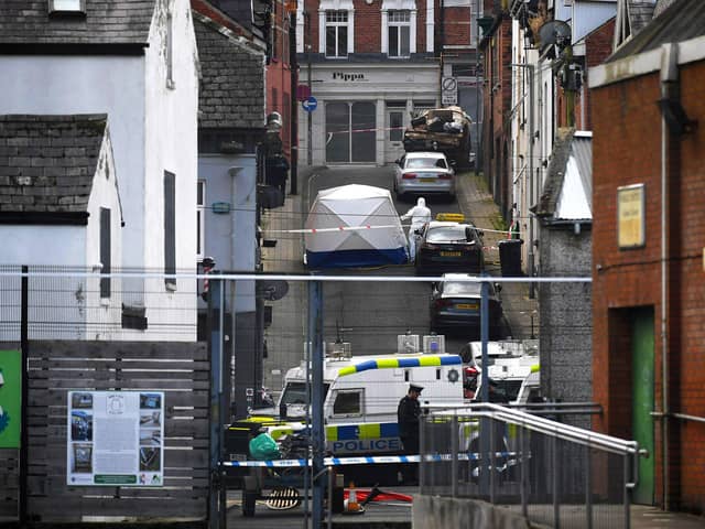 Forensic officer attends the scene of a suspicious death of a woman in Harvey Street. Photo: George Sweeney