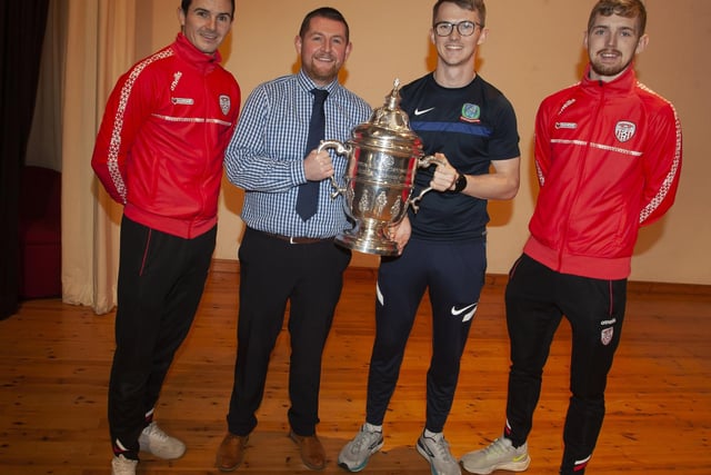 Members of the teaching staff at Oakgrove Integrated College get a photo taken with Derry City players Jamie McGonigle and Ciaran Coll and the FAI Cup.