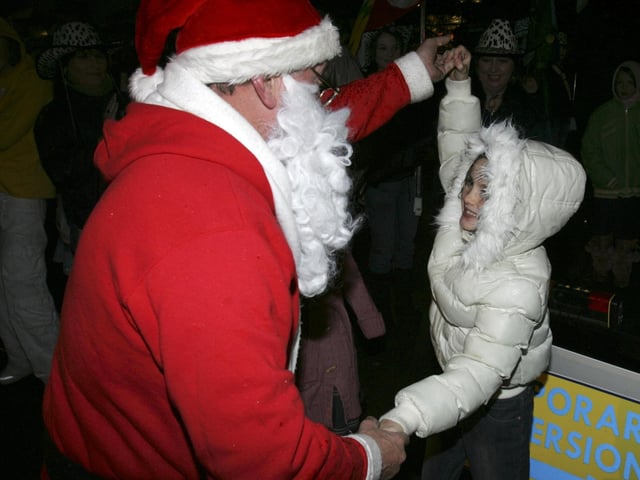 DANCING IN THE STREETS...Santa dancing with children on his arrival in the Market Square. (2911C31) : Christmas in Inishowen in 2005.