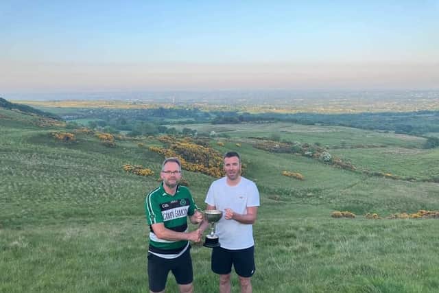 Na Magha's Gearalt Ó Mianáin receives the County Poc Fada title from Hurling Officer, Kevin Hinphey