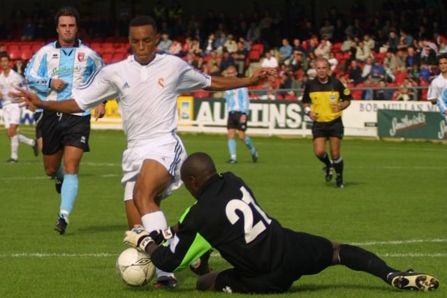 Derry keeper Russell Payne dives to the feet of a rushing Real Madrid forward.(2208JB84)