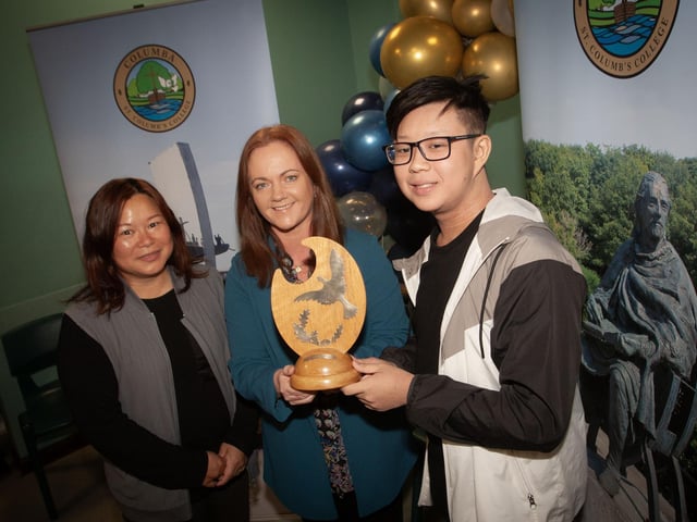 Mrs McCay, Acting Head of Art and Design presenting Marcas Yau with the Father McCarron Prize for Art and Design. On left is Marcas' mum.