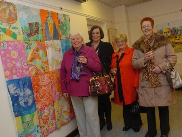 Local artists Geraldine, Caroline, tutor Geraldine, Marie standing beside their piece, Unique Batik by the pink ladies at the Women Building Bridges exhibition at the Eden Place Arts Centre held as part of international Women's day. (1103SL06)