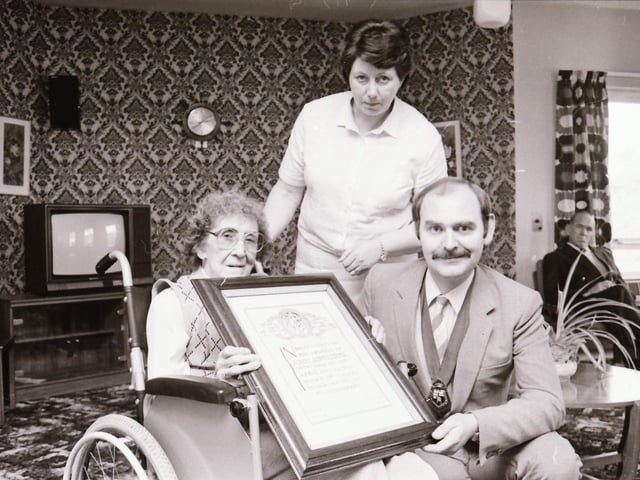 Derry Mayor Noel McKenna receiving scroll from Mrs Johnstone.