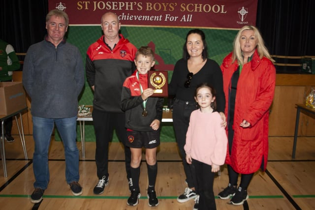 The late Sean O’Kane’s sister Ciara McGlynn presenting Shea O’Hara, Phoenix Athletic FC with the 2012 Plate trophy on Sunday. Included from left is Paul Kealey, Vice Principal, Chirsty McGeehan, organiser, and on right, Ciara Deane, Principal, St. Joseph’s Boys School.
