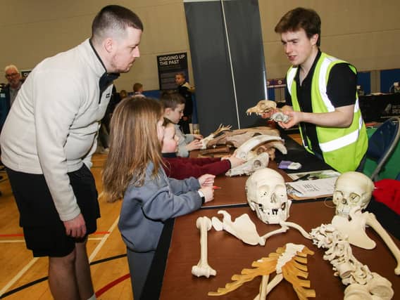 Brody McEvoy from CAPNI, with Evie and Charlie and their dad checking out skelton bones at The Foyle Science Showcase held in The Foyle Arena. (Photo - Deirdre Heaney, nwpresspics) : Foyle Arena Science Showcase.