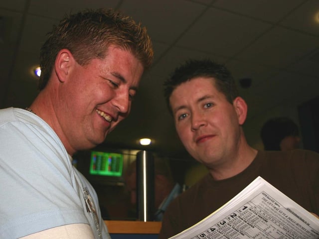 Kevin McDermott and Declan McDermott studying the form for the next race. 4869dd : A night at the races in Lifford in April 2005.