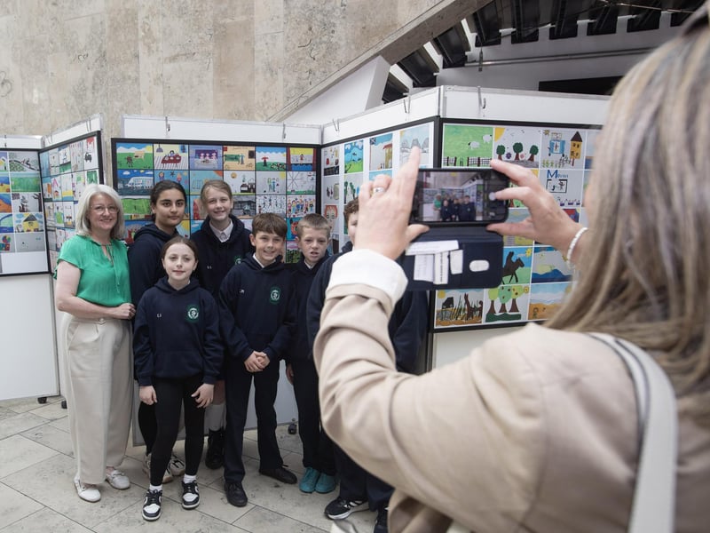 Children from St. Patrick's PS, Pennyburn get a photo taken beside their artwork.