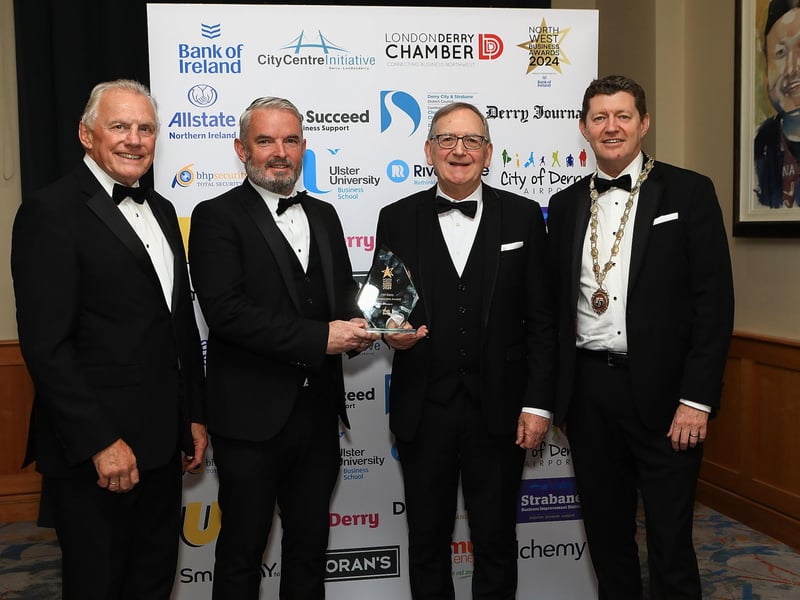 Ian Crowe, Secretary of CCI and Greg McCann, President of Londonderry Chamber of Commerce with Odhran Dunne, Chief Executive of Visit Derry, presenting Des Rainey with the Visit Derry Ambassadors Award.