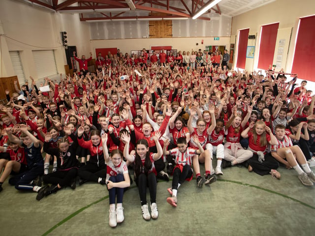 COME ON CITY!. . . . .A sea of red and white as Hollybush welcomes our parent Derry City players, Mark, Shane and Danny to the school on Tuesday afternoon. (Photos: Jim McCafferty Photography)