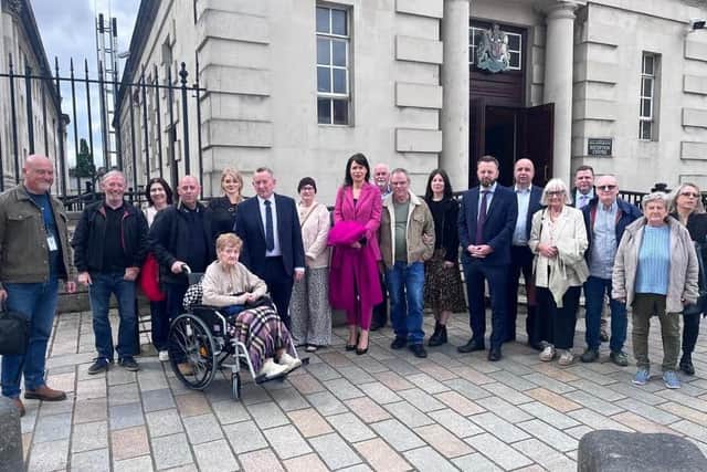 Mr John McDevitt with relatives and others as he attended a hearing earlier this year.