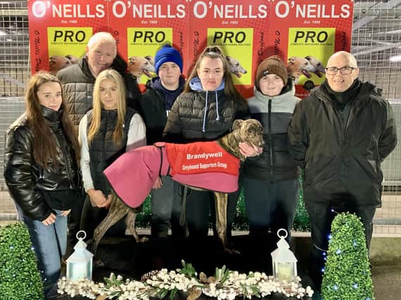 Ardnasool Luna who won the second race, the Brandywell Greyhound Supporters Group Sprint, in 17.11 with (from left) Chelsea Doyle, Matthew Talbot, Lauren McClay, Rian Ceallach & Shane Talbot & Patsy Doyle.