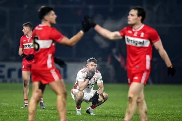 A dejected Matthew Donnelly of Tyrone as Gareth McKinless and Padraic McGrogan of Derry celebrate after the Allianz Football League Division 2 match between Derry and Tyrone at Celtic Park in Derry. Photo by Oliver McVeigh/Sportsfile