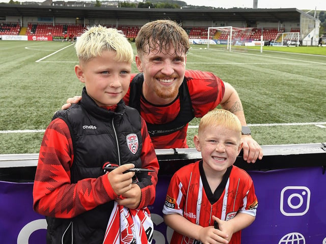 Alex Bannon poses for a photo with fans at the Derry City open training session on Monday morning in  Brandywell Stadium. The event was organised at part of the Gasyard Feile.  Photo: George Sweeney / Derry Journal