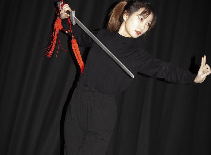 One of the traditional Chinese dancers performing a sword dance at Steelstown PS last week.