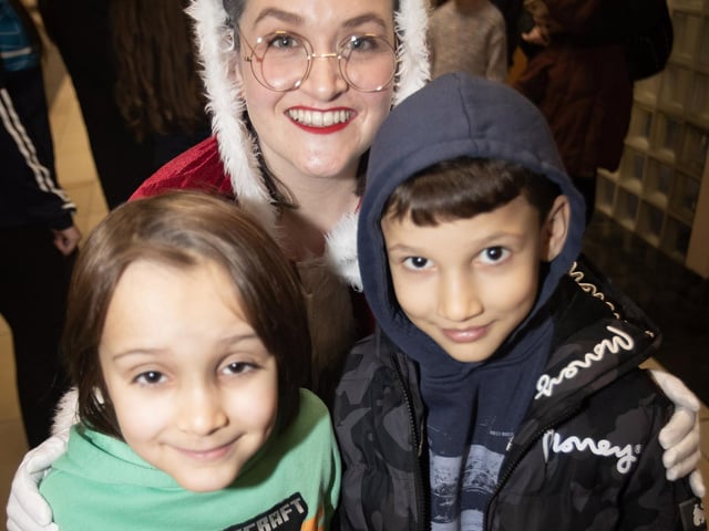 Mrs. Claus pictured with some of the children waiting to see Santa on Saturday. : .